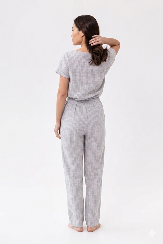 Woman wearing a gray checkered outfit on a white background