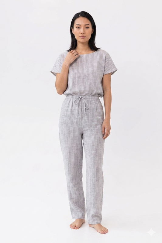 Woman wearing a gray checkered outfit on a white background